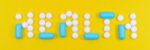Pills spelling 'health' on a vibrant yellow background, symbolizing wellness.